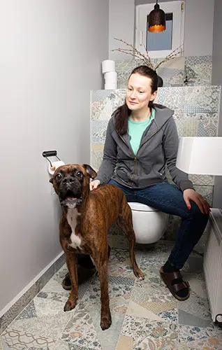 dog and woman on toilet